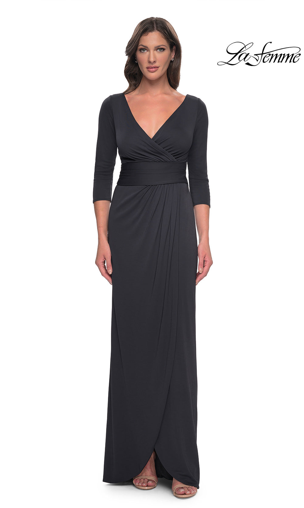 Woman wearing a black evening gown with a V-neckline and three-quarter sleeves on a white background.