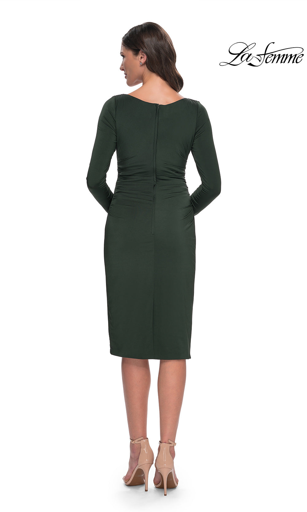 Woman wearing a green dress with long sleeves on a white background