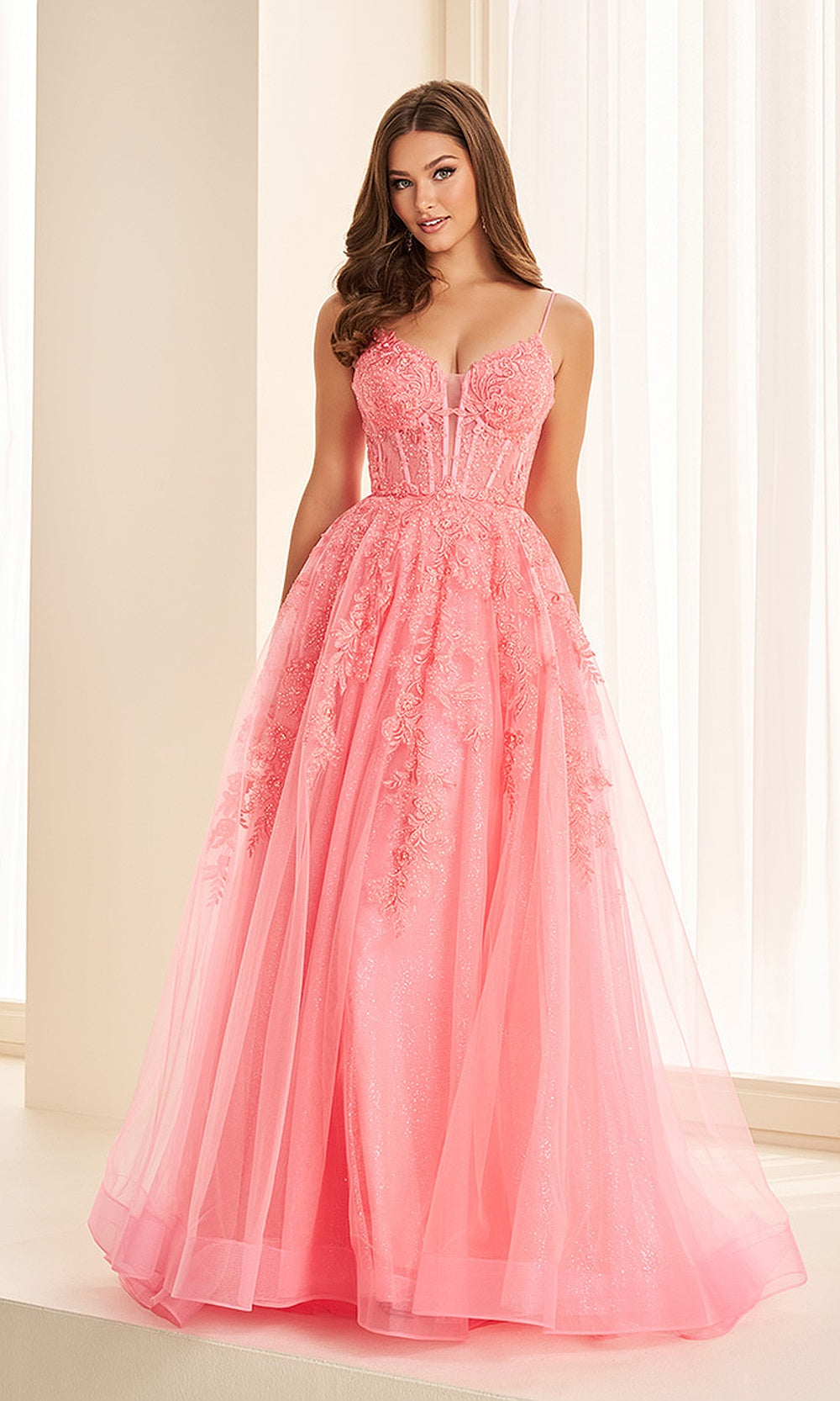 Ellie Wilde EW34036 Coral prom dress front view with glitter tulle, floral appliqués, sweetheart neckline, ballgown silhouette, pageant-ready gown.
