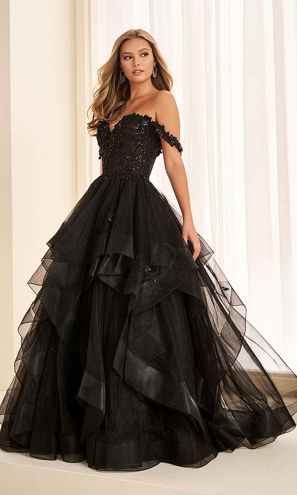 Ellie Wilde EW35084 Black prom dress front view with glitter tulle, floral appliques and beading, off-shoulder sweetheart ballgown silhouette, a stunning formal prom gown.