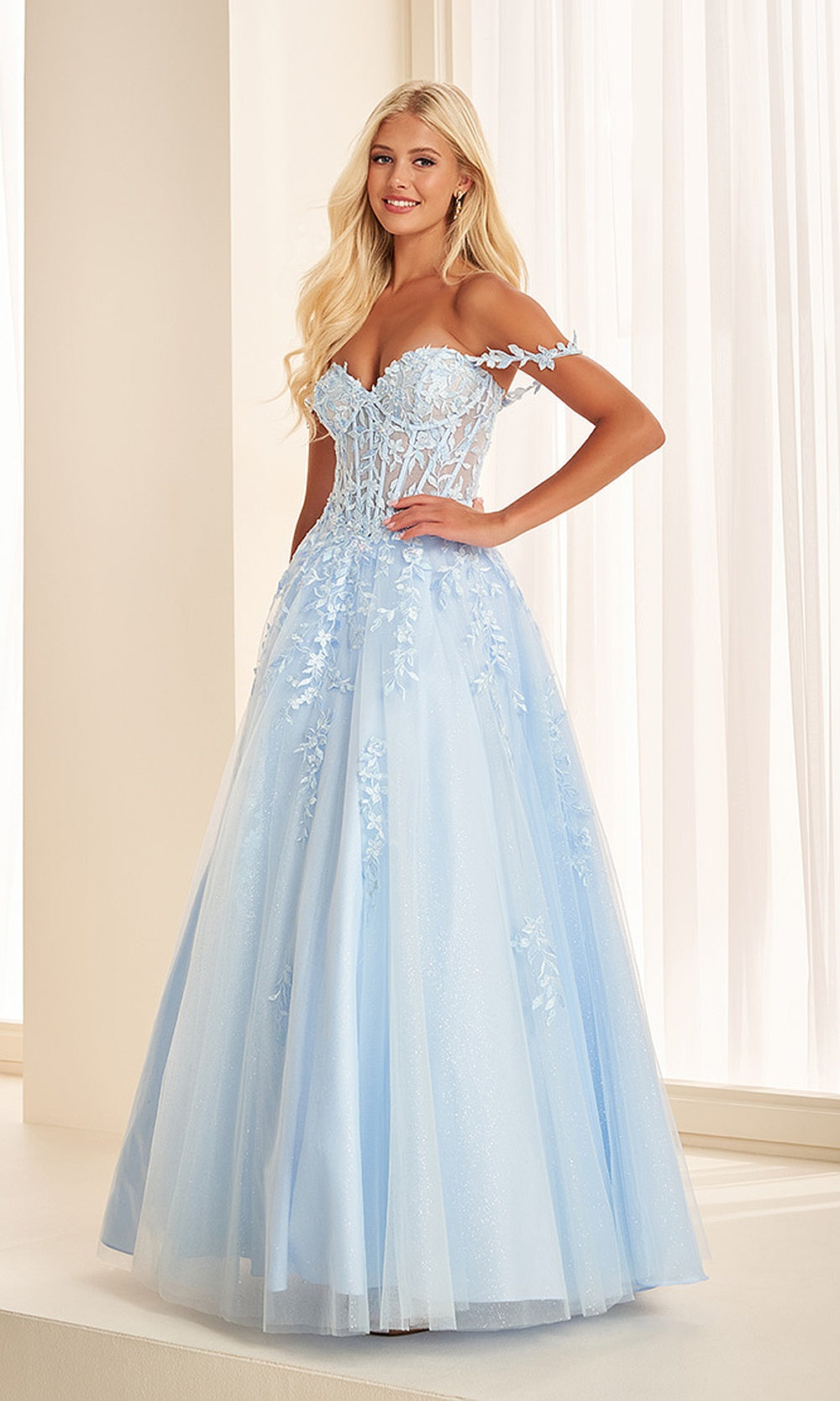 Ellie Wilde EW37028 Light Blue prom dress front view with tulle and lace, floral appliqués with beading, off-shoulder sweetheart neckline, corset ballgown silhouette, black tie event dress.