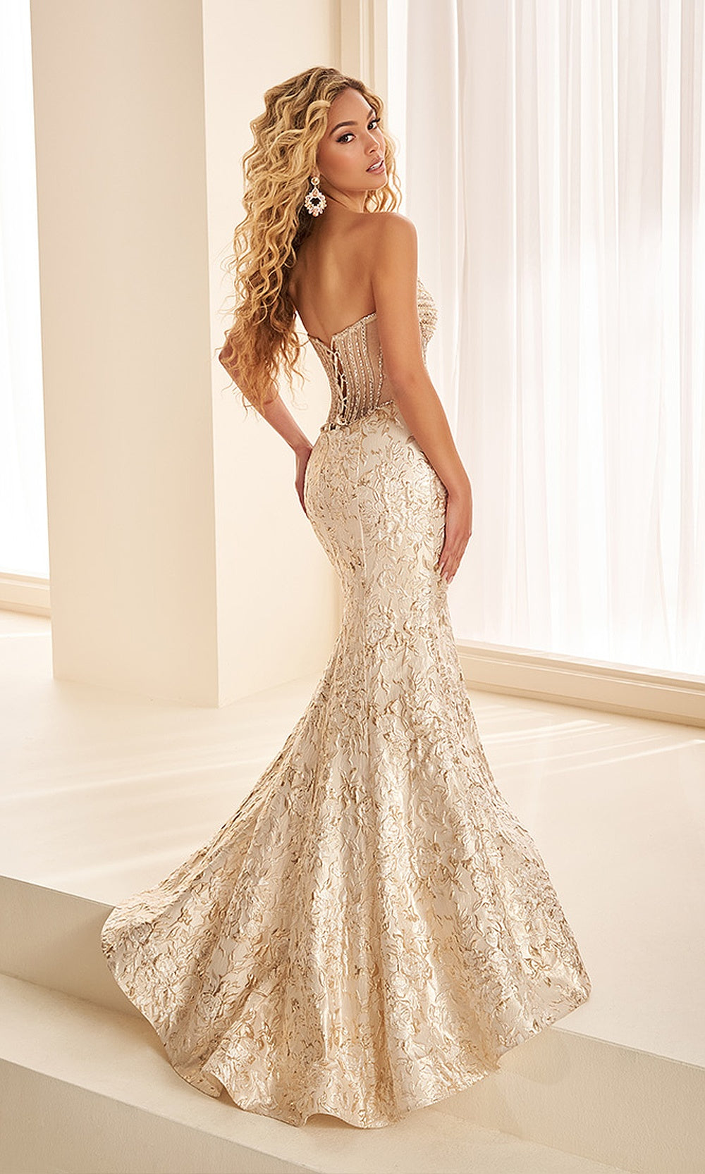 Ellie Wilde EW38065 Ivory/Light Gold back view prom gown with illusion sheer panel, crisscross lace-up closure, fitted metallic skirt, evening gown