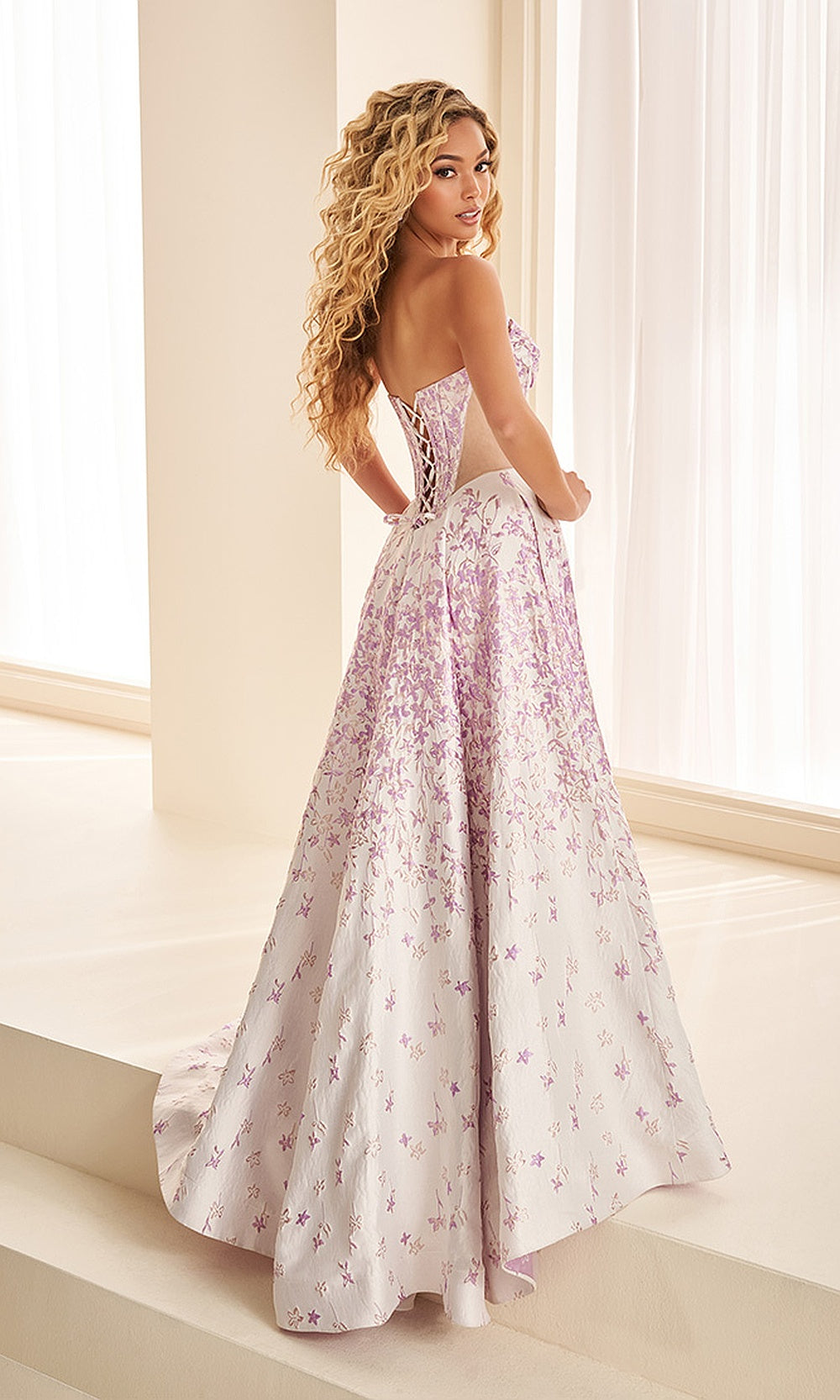 Ellie Wilde EW38084 Lilac Multi prom ballgown back view showing crisscross lace-up corset back, illusion panel, sweep train, evening gown for sweet 16