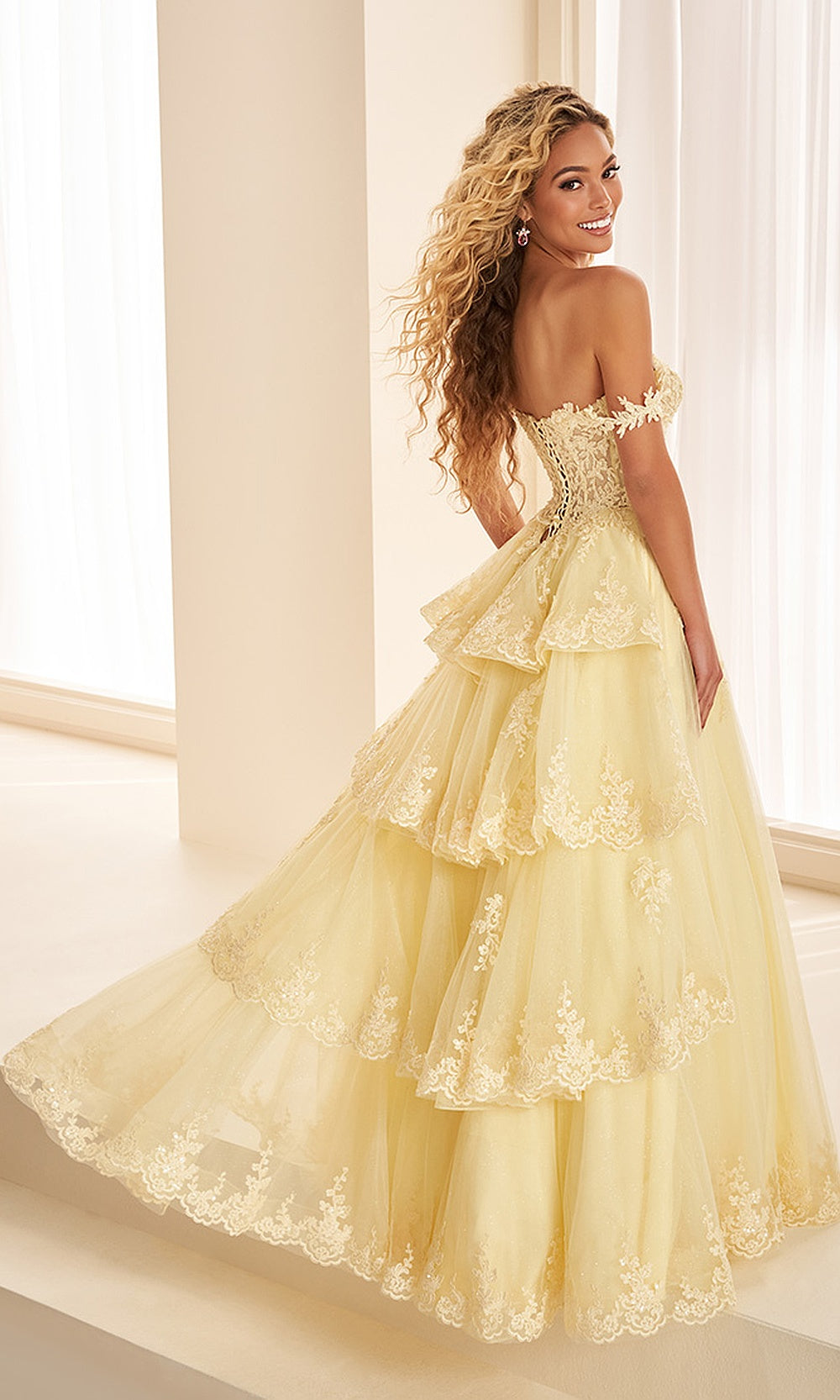 Ellie Wilde EW38092 Light Yellow prom dress back view with lace corset-back, boning, sweep train, and tiered tulle skirt for an elegant evening gown.