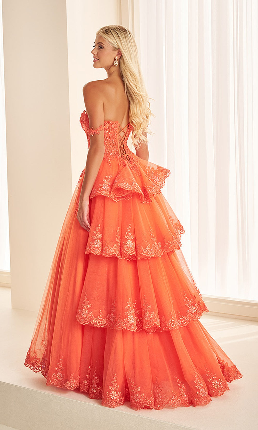 Ellie Wilde EW38092 Vermillion Orange prom dress back view with lace corset-back, sweep train, beading, and layered tulle skirt for a bold prom night look.