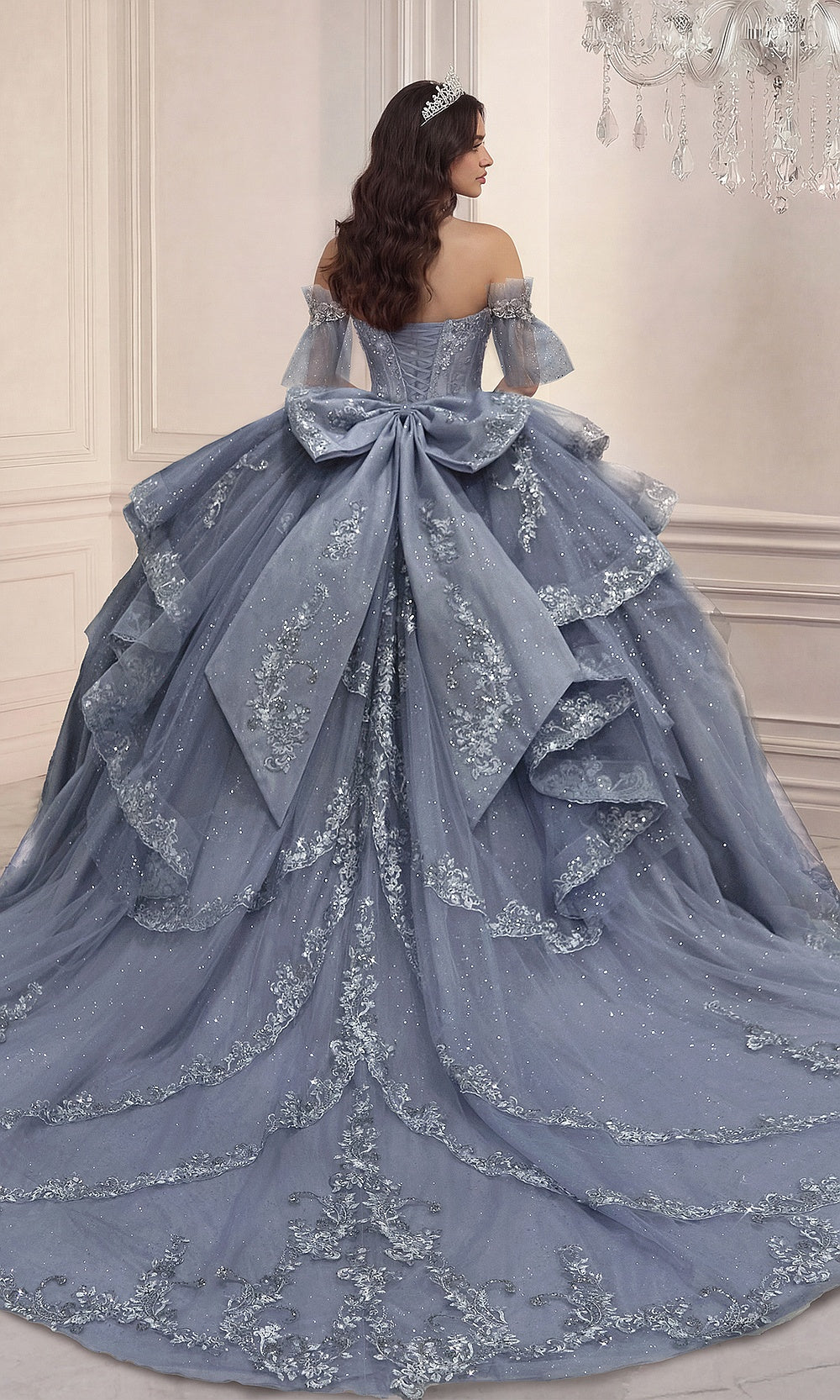 Ladivine 15741 Dusty Blue back view quinceanera gown with lace-up corset-back closure, large bow, detachable puff sleeves, cathedral train, debut ball gown