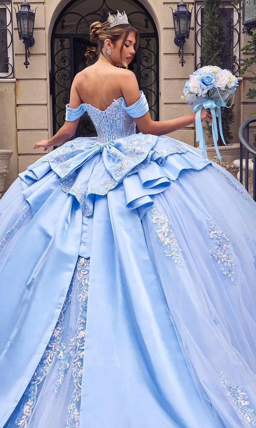 Ladivine 15745 Light Blue back view quinceañera ballgown full-length silhouette with tiered satin bow, voluminous tulle underlayers, corset-back closure, sweet 16 ball gown