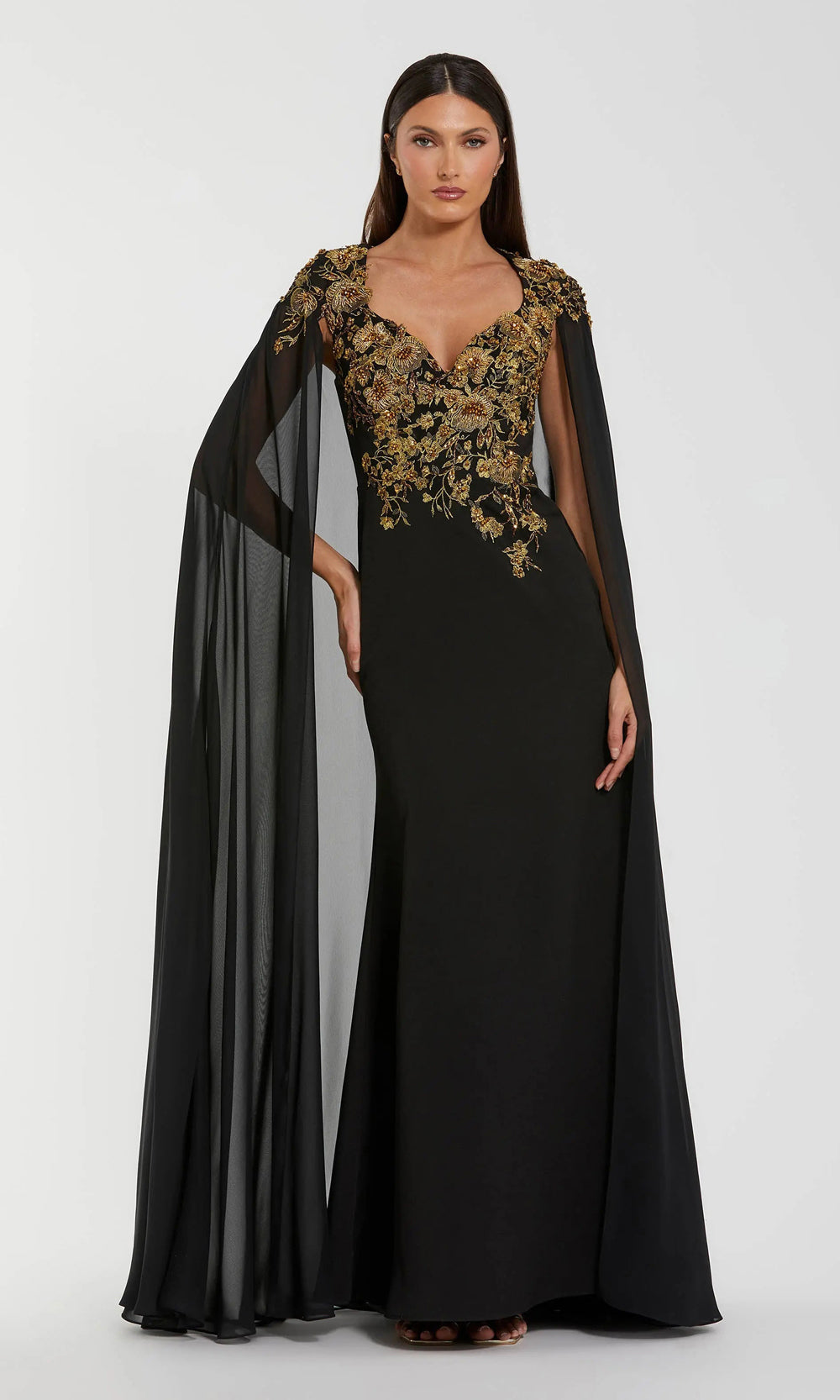 Mac Duggal 13206 black-gold front view formal gown with jersey fabric, gold floral beaded embroidered bodice, fitted silhouette, floor-length chiffon cape, formal evening gown