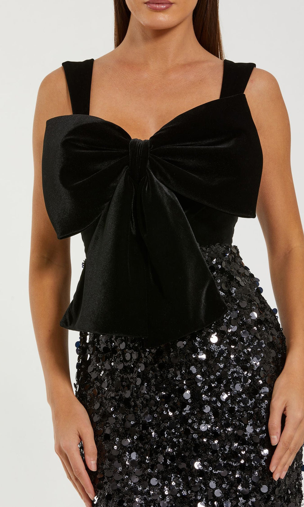 Mac Duggal 27777 Black cocktail dress detail view showing sweetheart neckline dip, velvet bow at center front, wide velvet straps, paillette sequin skirt surface, cocktail party dress