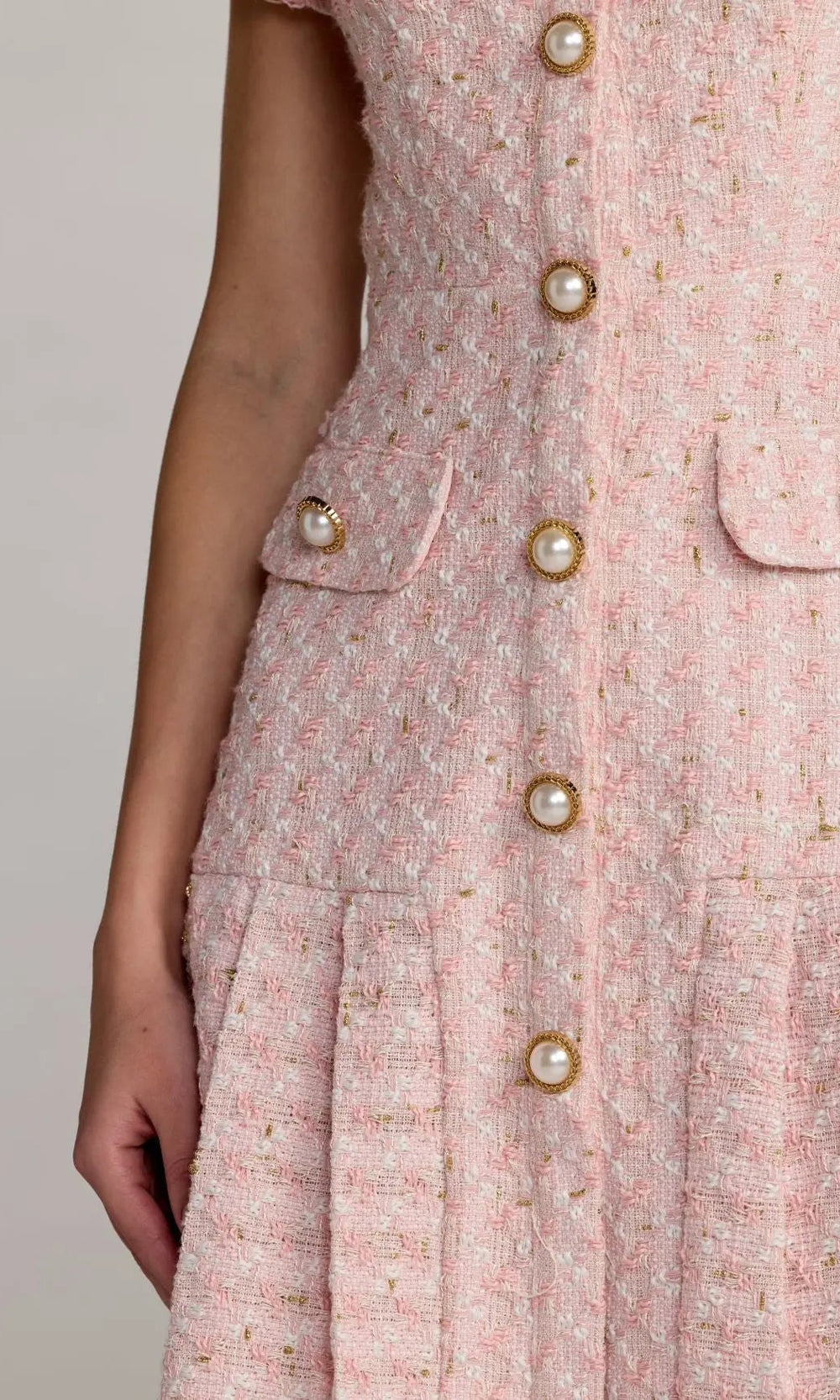 Mac Duggal 56379 Pink boucle tweed detail view showing pleated kick-flare hem with frayed boucle edge, short fit-and-flare cocktail dress