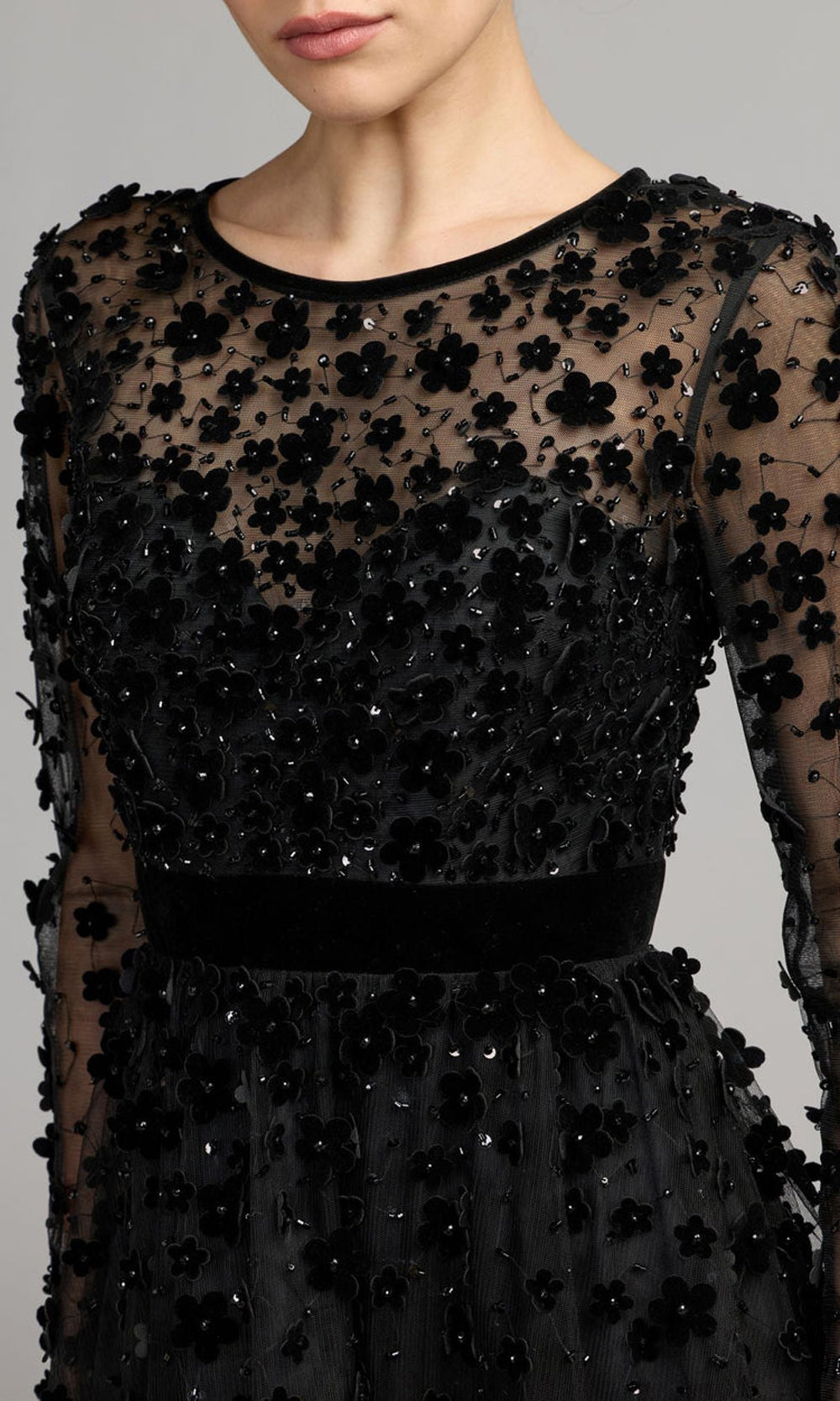 Mac Duggal 9969200P black detail view velvet floral appliqués with scattered beading and sequin accents on illusion mesh, evening gown surface texture, a prom favorite