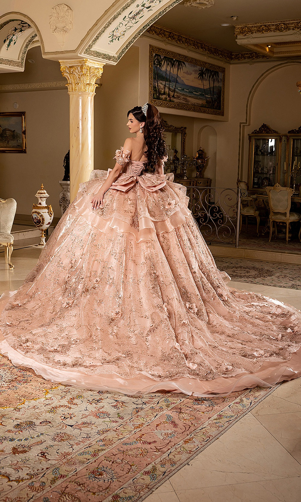 May Queen LK295 rose gold quinceañera gown — angled back view of the ruffle skirt and sweeping train