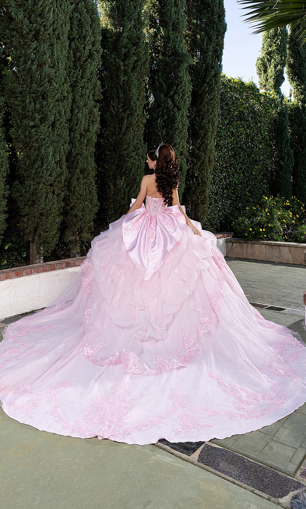 May Queen LK299 pink quinceañera gown — garden back view of the bow and sweeping glitter train