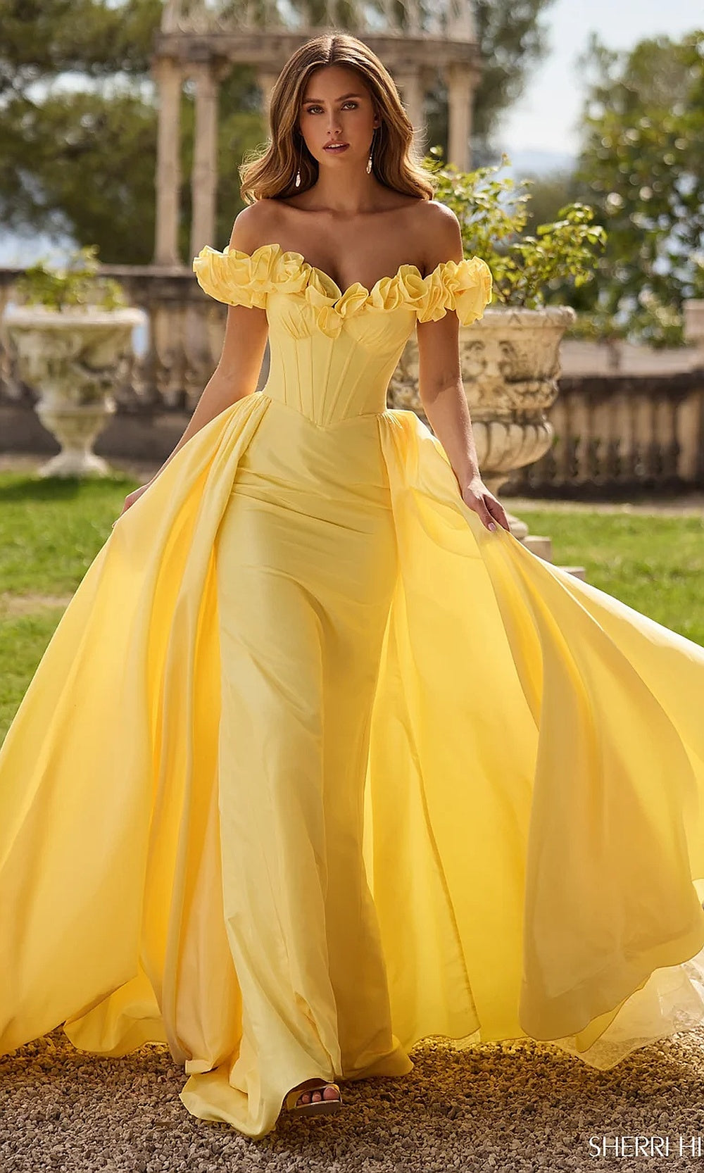 Sherri Hill 57200 Yellow prom gown front view with chiffon organza overskirt, off-shoulder 3D floral appliqués, boned sweetheart corset bodice, formal prom gown