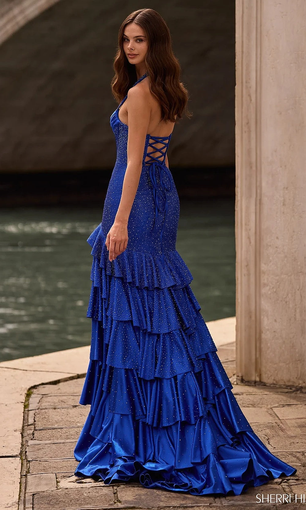 Sherri Hill 57618 Royal prom dress side view, fitted stretch jersey silhouette with tiered ruffle skirt layers and floor-length train, evening gown