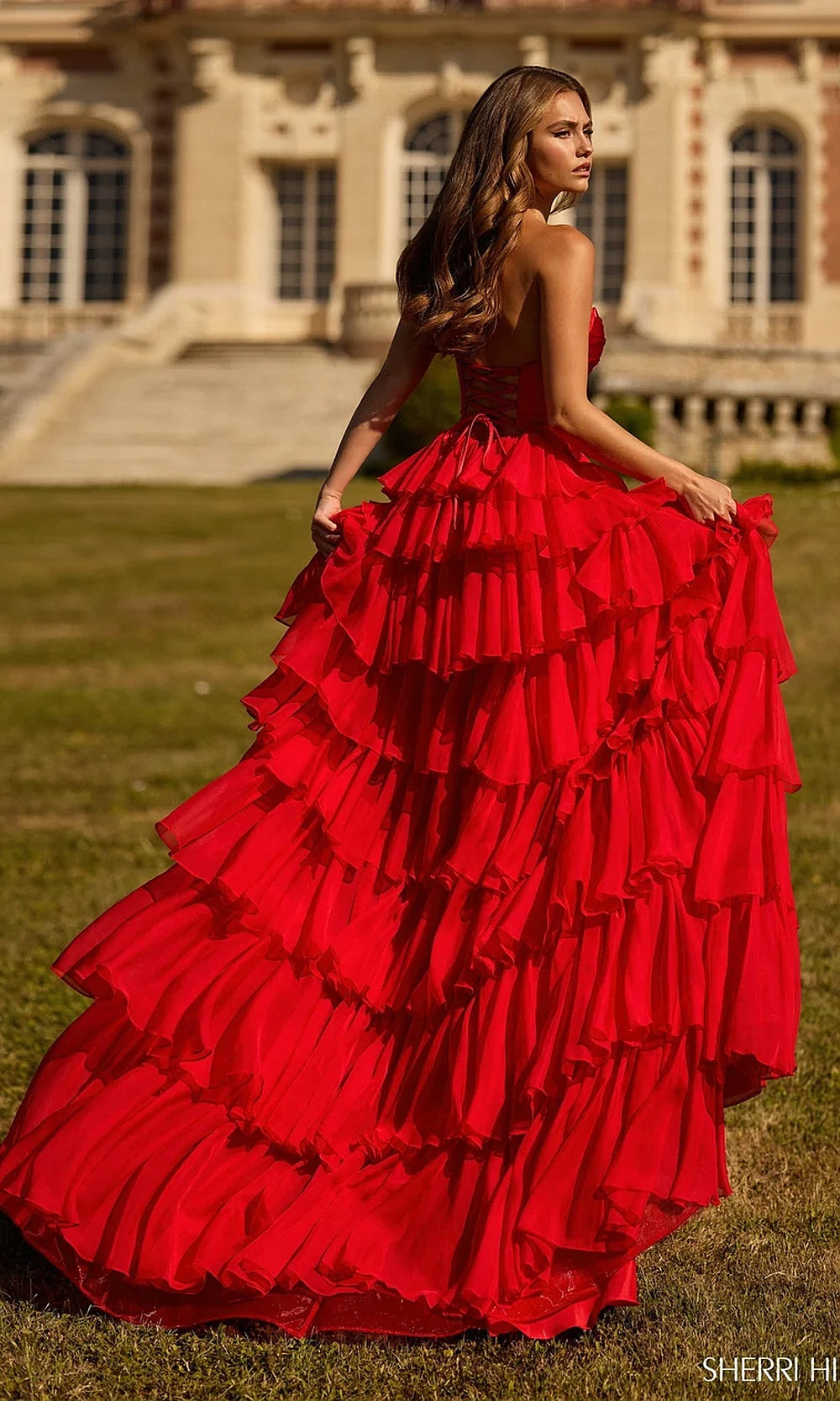 Sherri Hill 57705 Red prom dress back view with fully open back above ruffled chiffon skirt, strapless silhouette, evening gown for prom