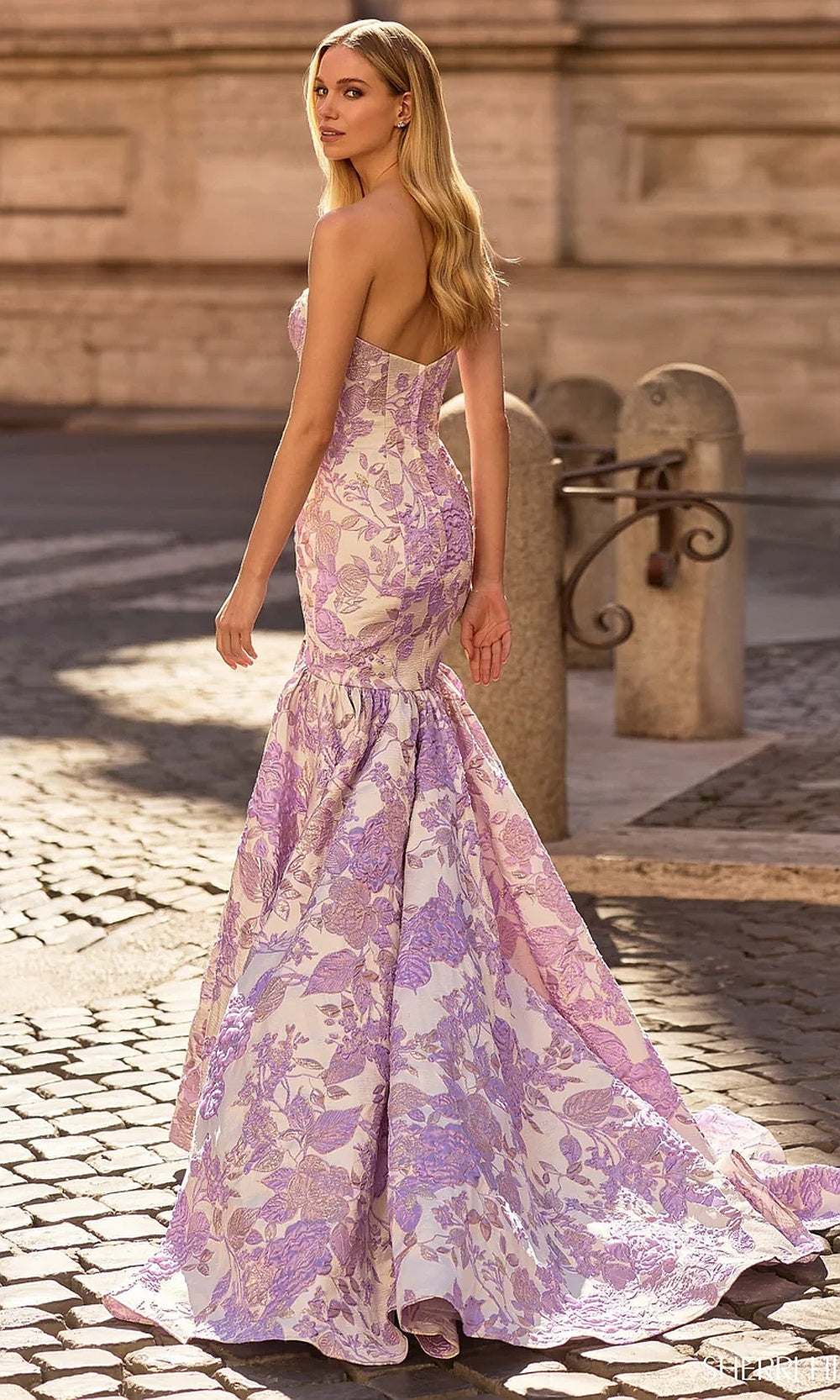 Sherri Hill 57785 Lilac floral mermaid trumpet prom gown back view showing fully open back, sweep train, boning detail, evening gown