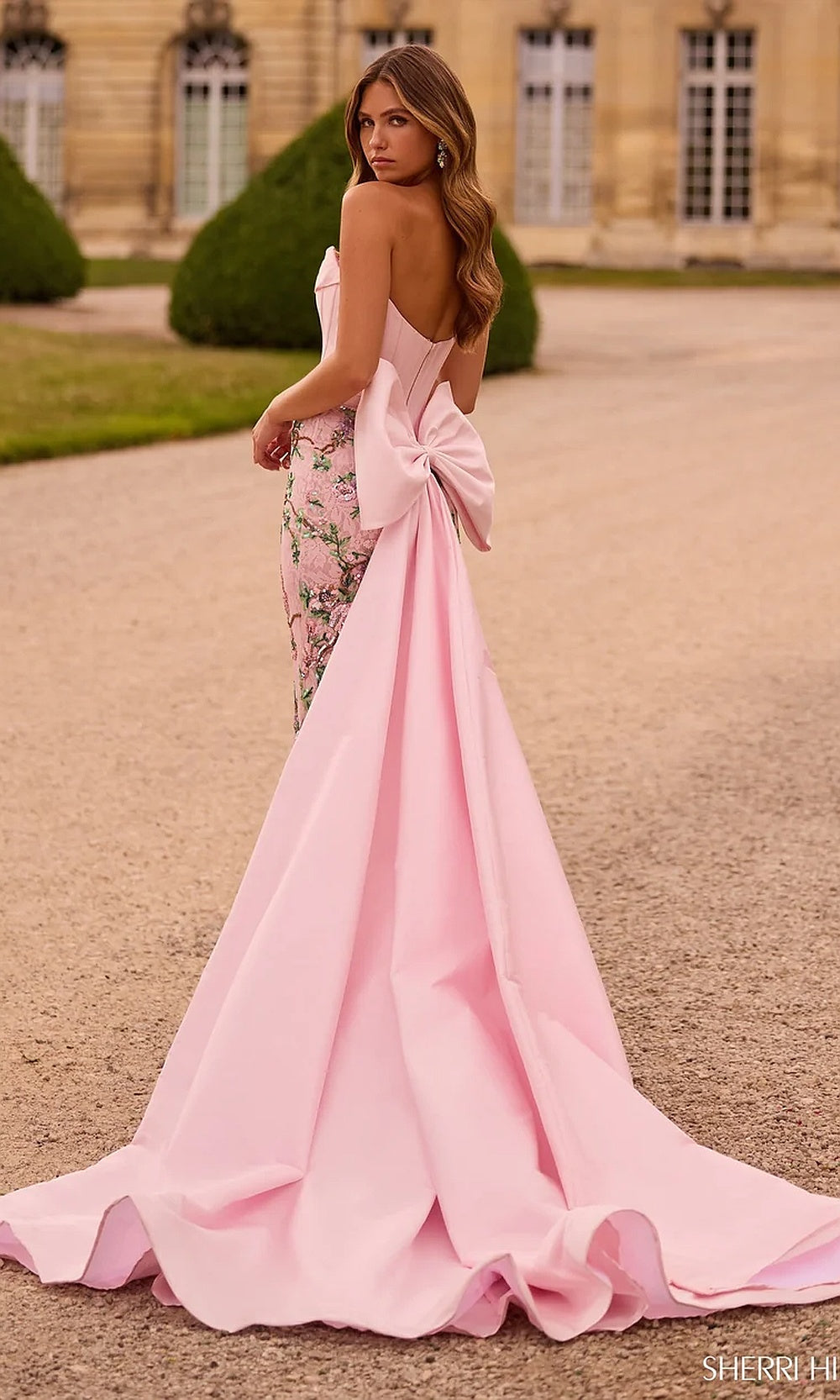 Sherri Hill 57795 Light Pink Print prom dress back view with satin bow train open back corset fitted silhouette evening gown