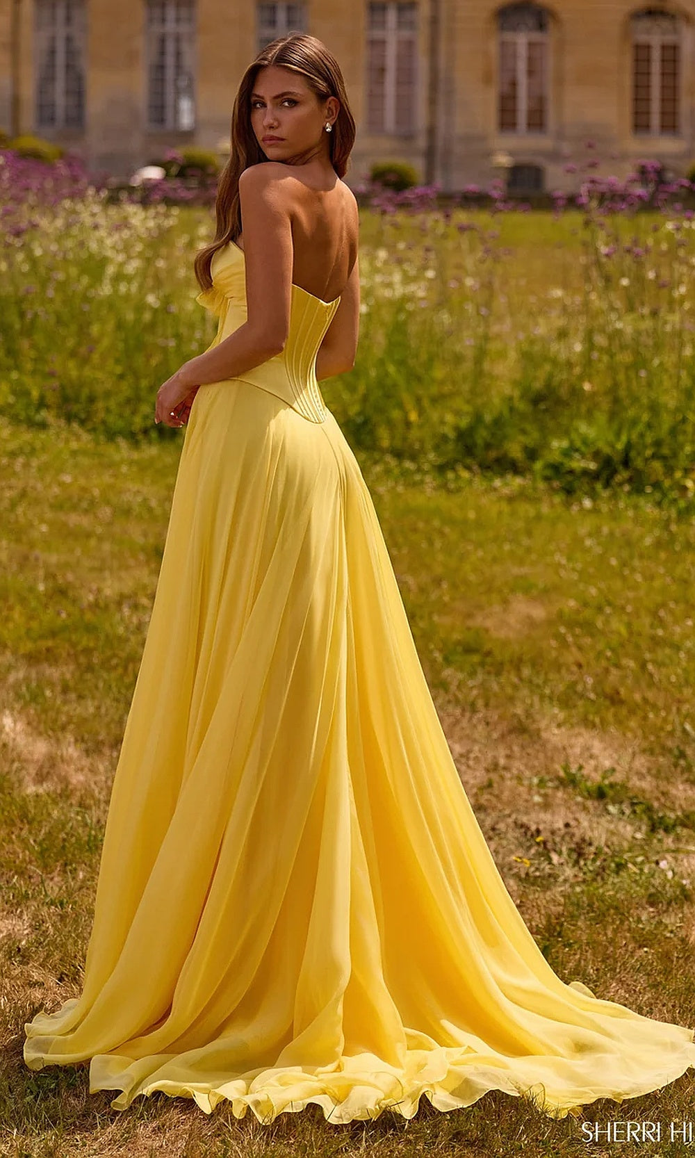 Sherri Hill 57810 Light Yellow prom gown back view with fully open back, chiffon train, boned satin bodice, evening gown