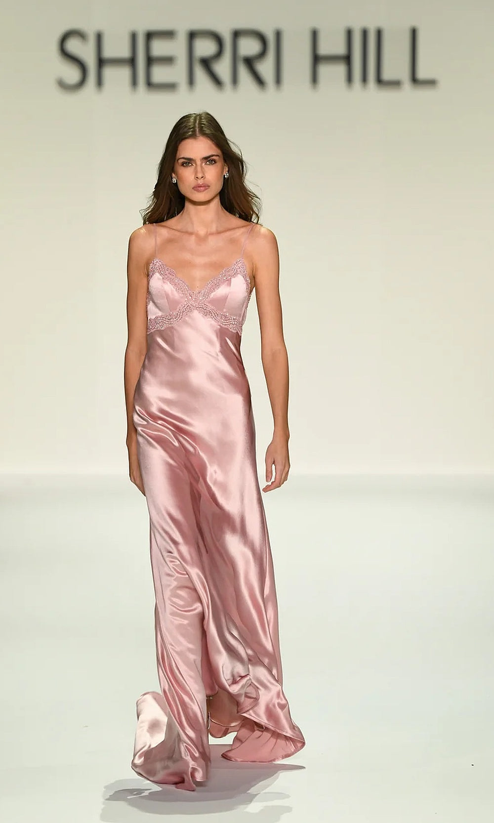 Sherri Hill 57822 pink prom gown editorial view in long fitted satin with V-neckline, beaded scalloped trim, open back, and subtle train, red carpet styling