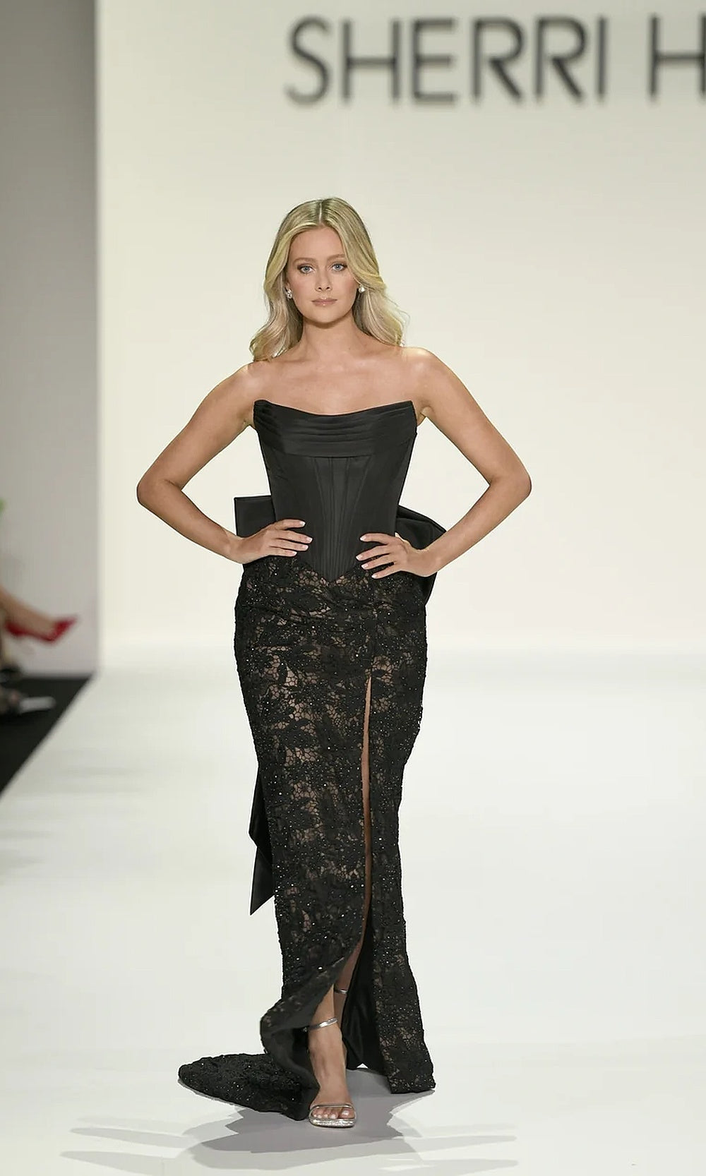 Sherri Hill 57921 Black prom gown full view with beaded lace skirt, satin corset bodice, waist bow, front slit, fitted silhouette, formal prom gown