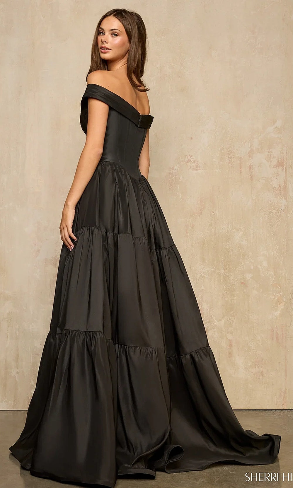 Sherri Hill 57945 Black prom ballgown with floor-sweeping train, tiered ruffle skirt and boned off-shoulder corset, side view, evening gown for formal events