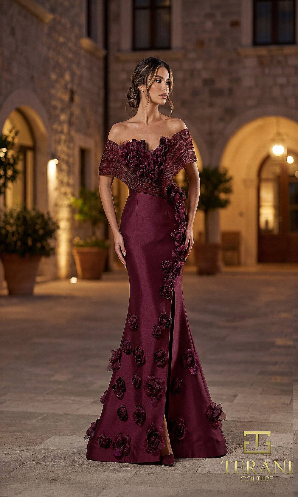 Terani Couture 262E7070 Wine formal evening dress front view with off-shoulder notched neckline with 3D rosettes, satin column gown with cascading floral appliqué and slit, black tie event dress