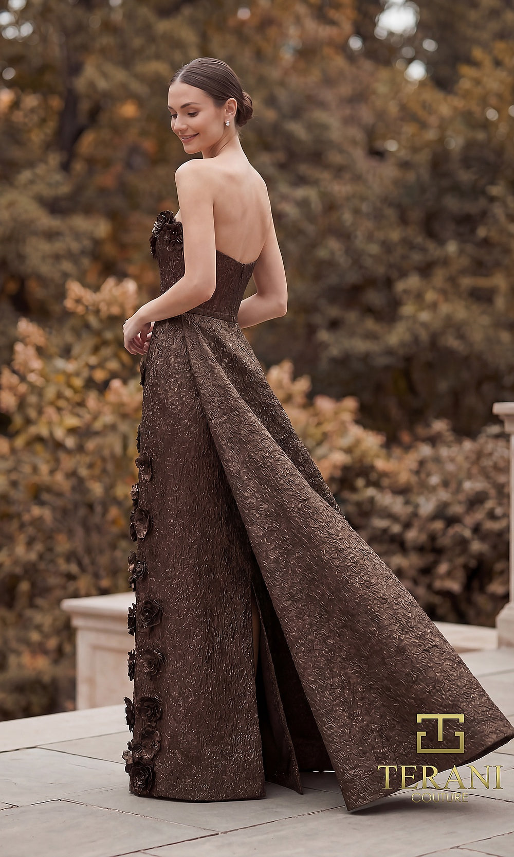 Terani Couture 262E7093 Bronze formal evening dress back view with strapless metallic brocade gown, 3D rosettes, dramatic back overskirt train, gala gown