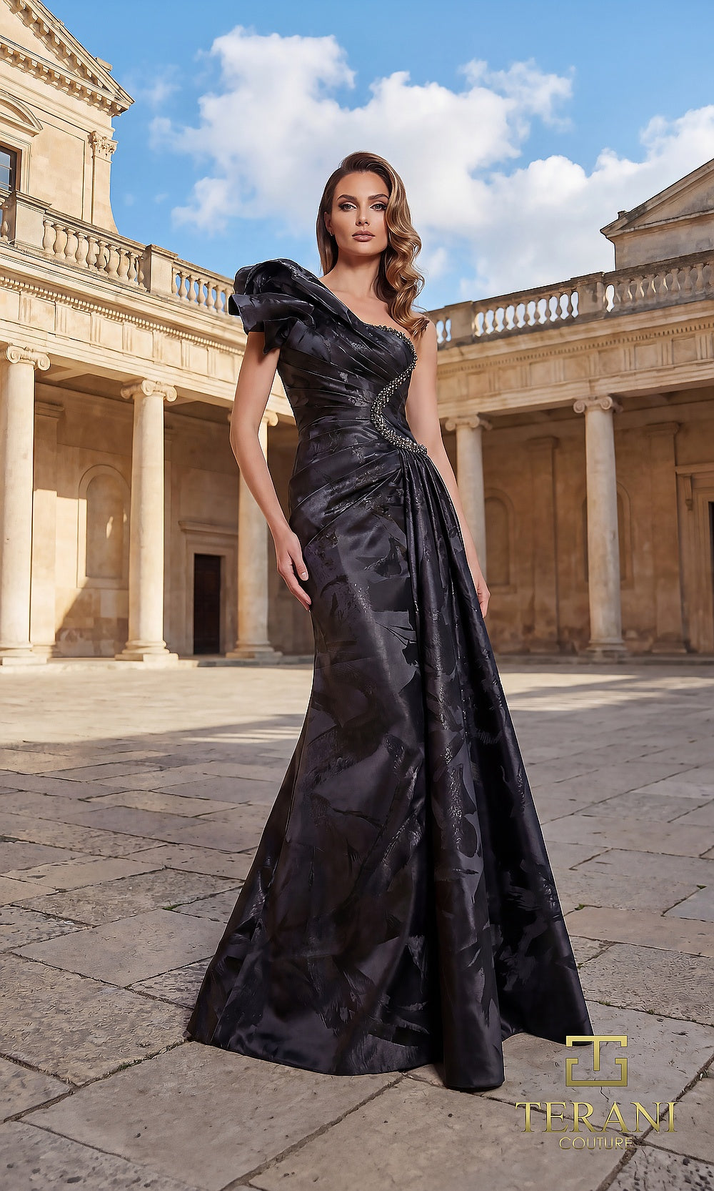 Terani Couture 262E7376 Black formal evening dress front view with one-shoulder ruffled bow neckline, tonal floral jacquard draped A-line gown, black tie event dress