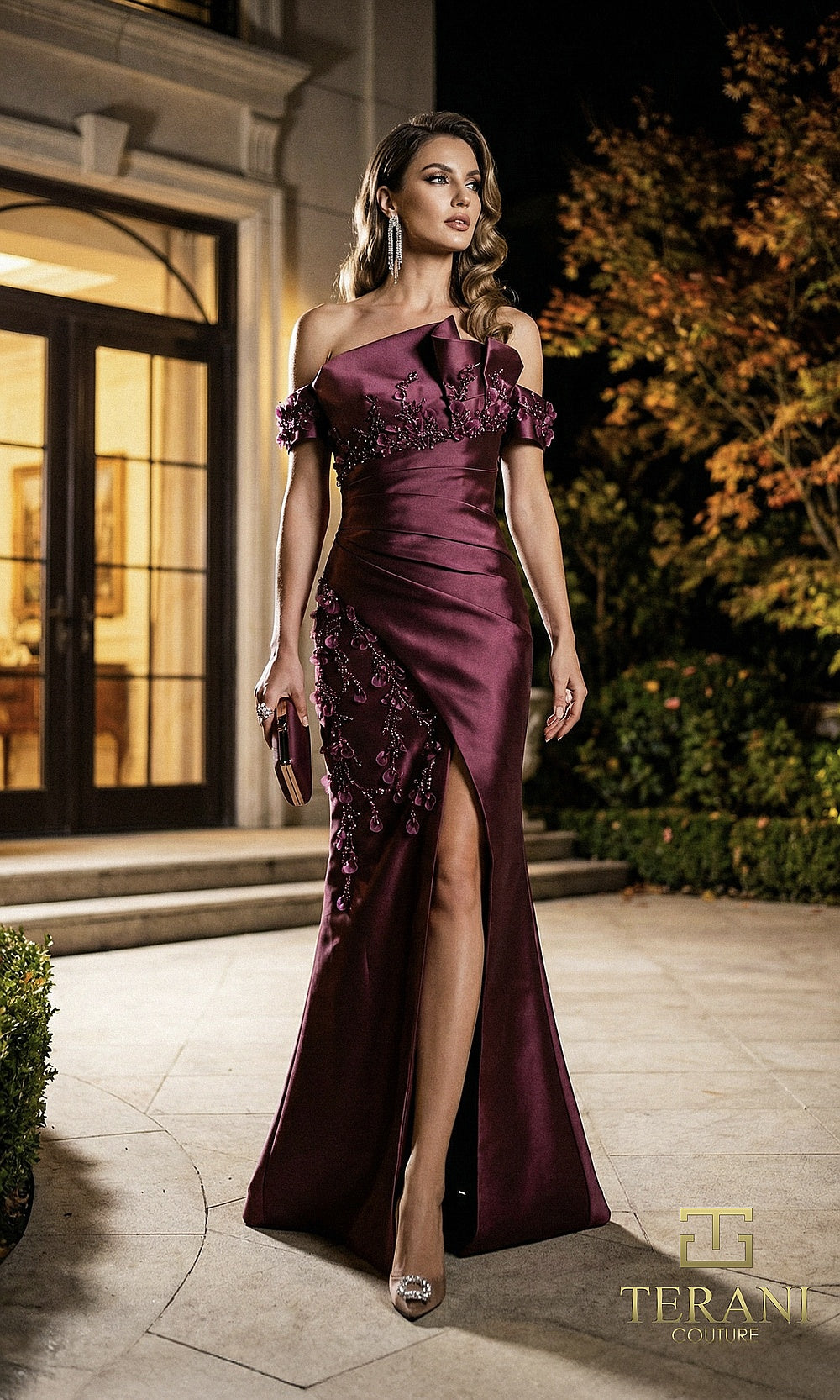 Terani Couture 262M7254 Wine mother of the bride dress front view with off-shoulder notched neckline, 3D floral appliqué cascade, satin column with thigh slit, mother of the bride styling