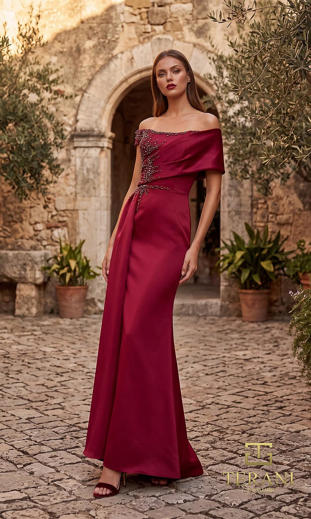 Terani Couture 262M7278 Wine mother of the bride dress front view with off-shoulder folded neckline, beaded pleated bodice, satin column with draped overskirt, mother of the bride styling