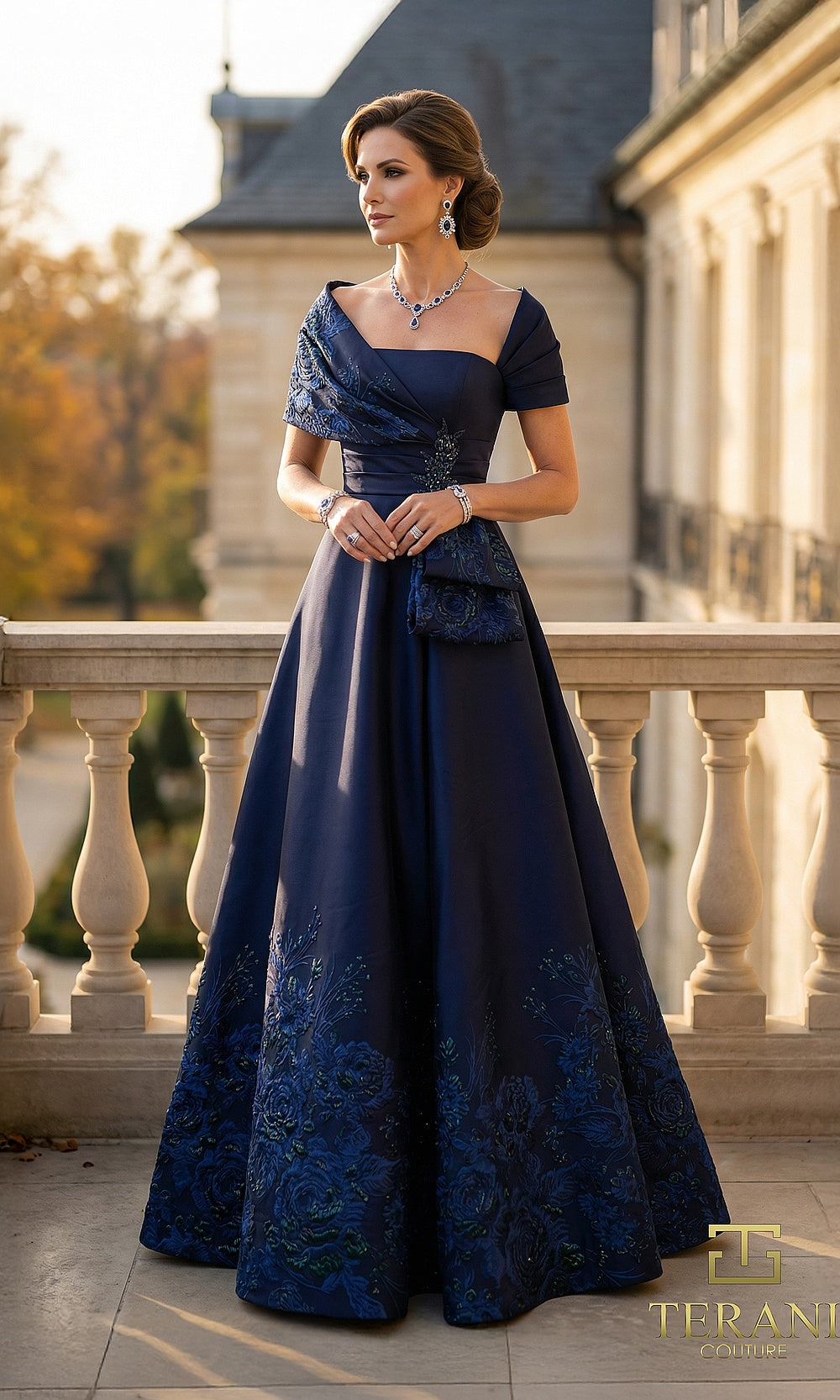 Terani Couture 262M7323 Navy mother of the bride dress front view with asymmetric portrait neckline and short sleeves, satin A-line ballgown with beaded floral embroidered hem and side bow, mother of the bride styling