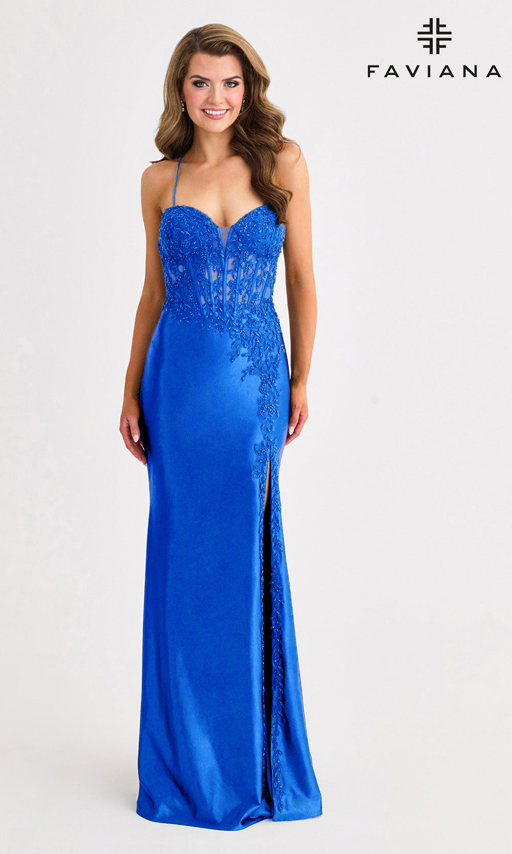 Woman wearing a blue evening gown with a side slit on a white background, branded 'Faviana'.