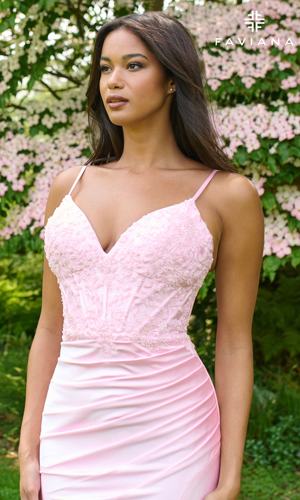 Woman wearing a pink dress with a floral background