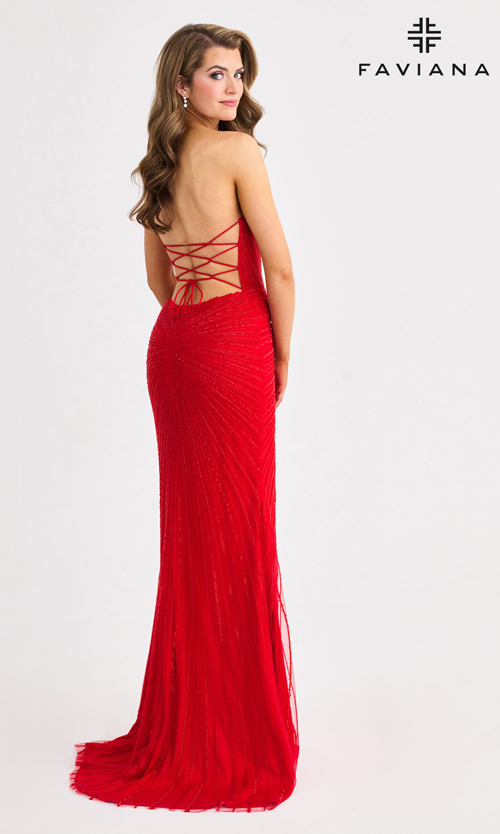 Red evening gown with open back on a white background, featuring the Faviana brand.