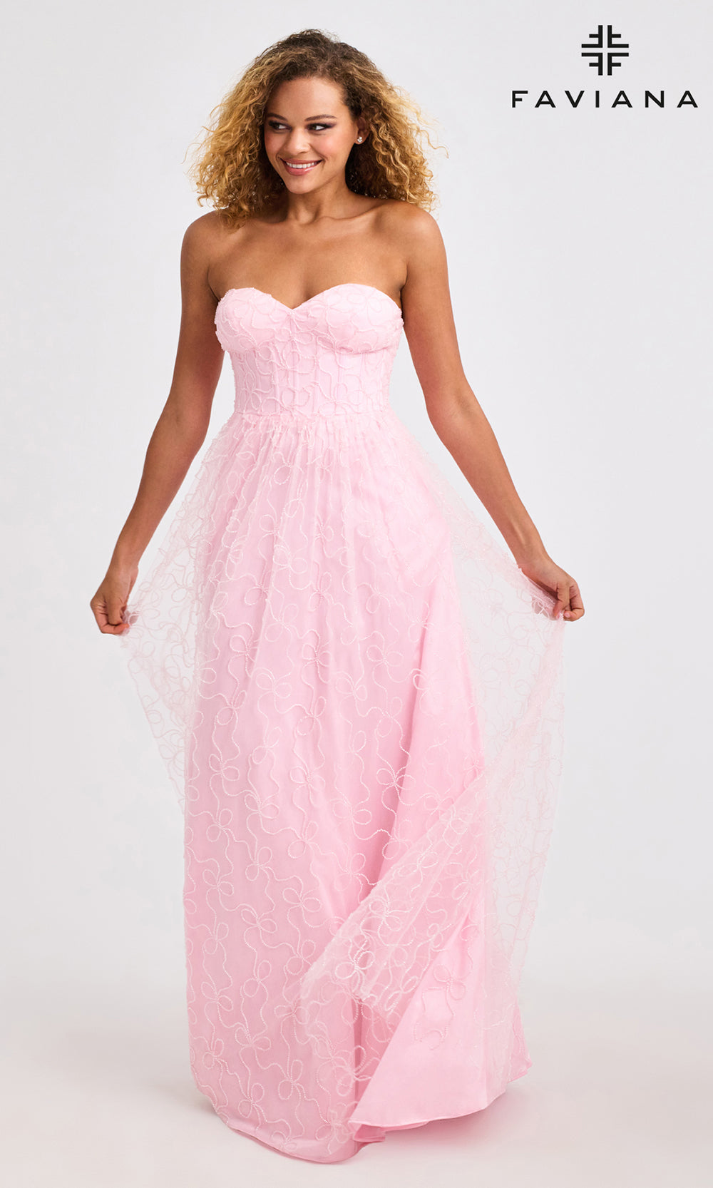 Woman wearing a pink strapless gown with Faviana branding on a white background