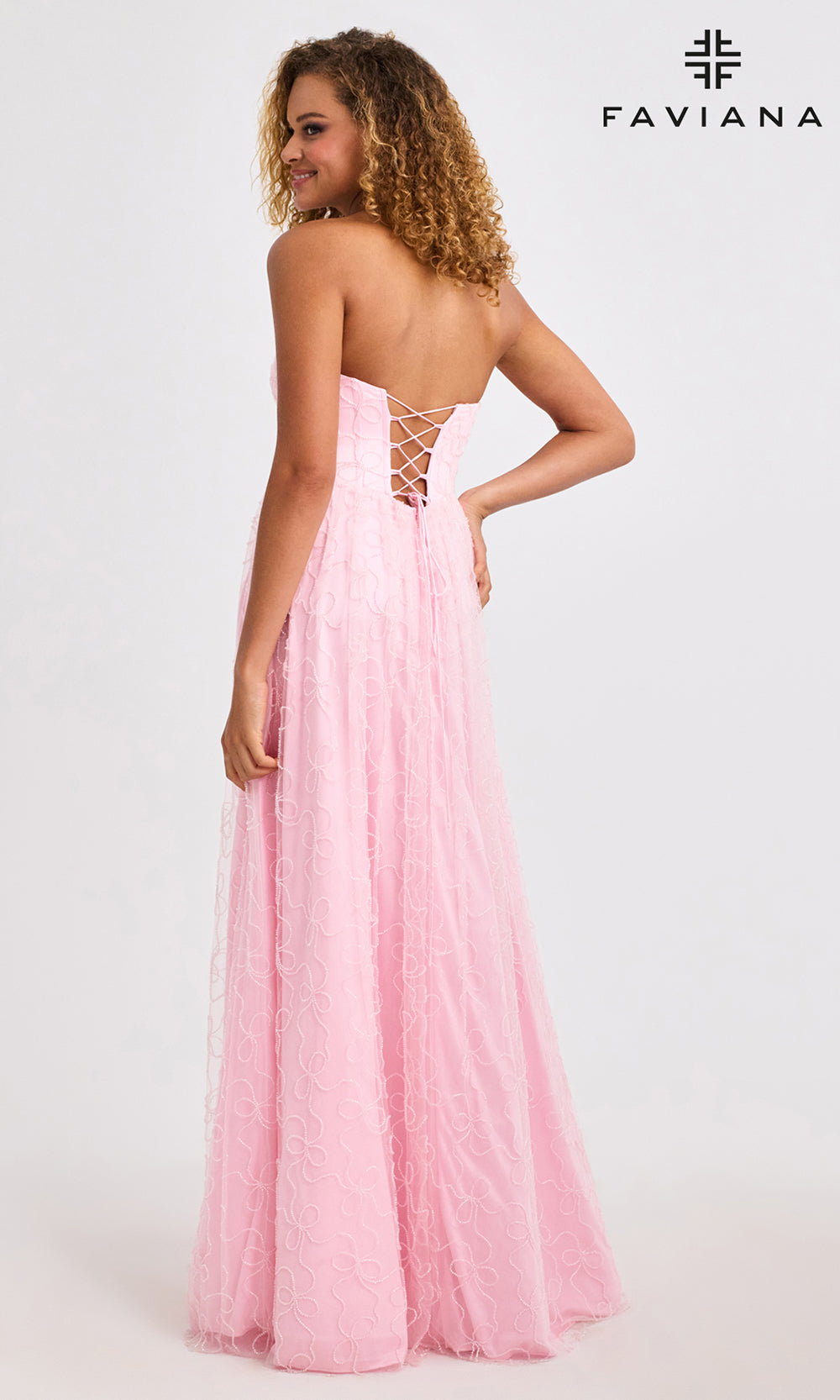 Woman wearing a pink evening gown with 'Faviana' branding on a white background