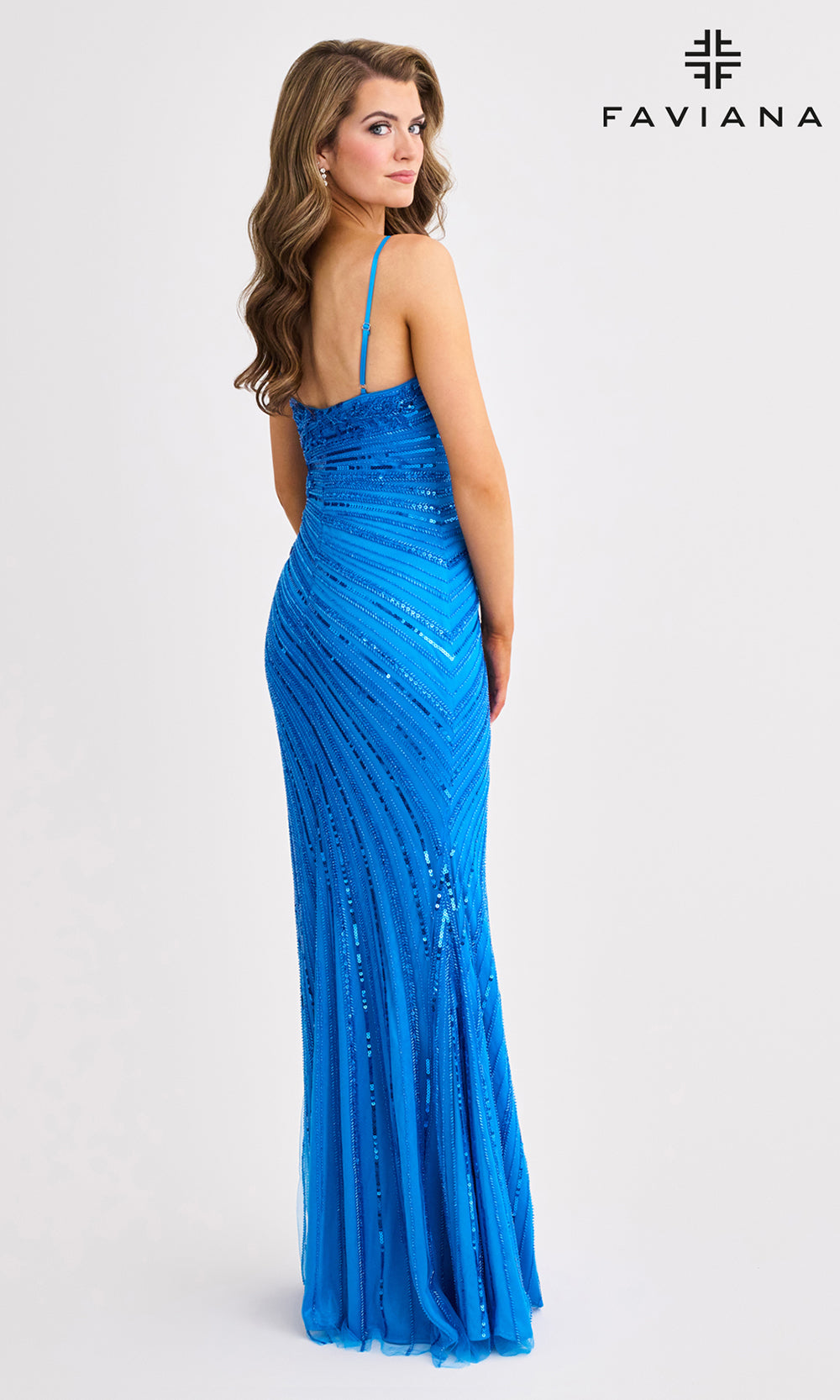 Woman wearing a blue evening gown with 'Faviana' branding on a white background