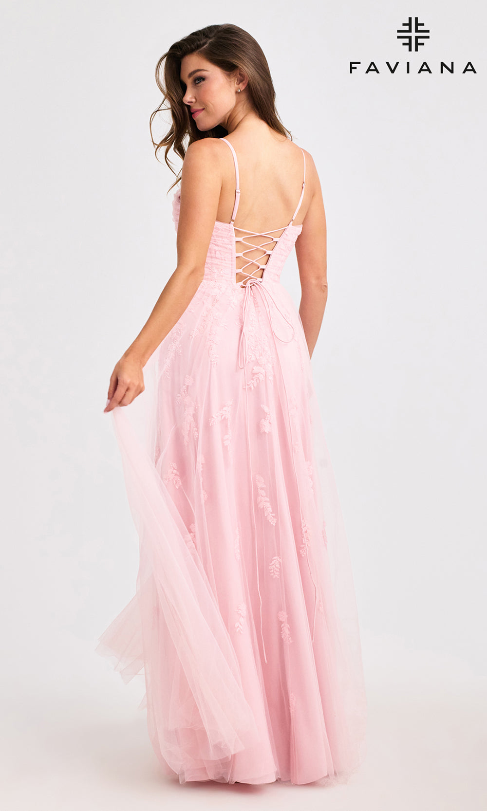 Pink evening gown with lace-up back on a white background, featuring the Faviana brand.