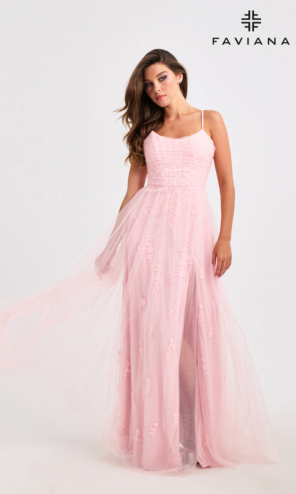 Woman wearing a pink dress with Faviana branding on a white background