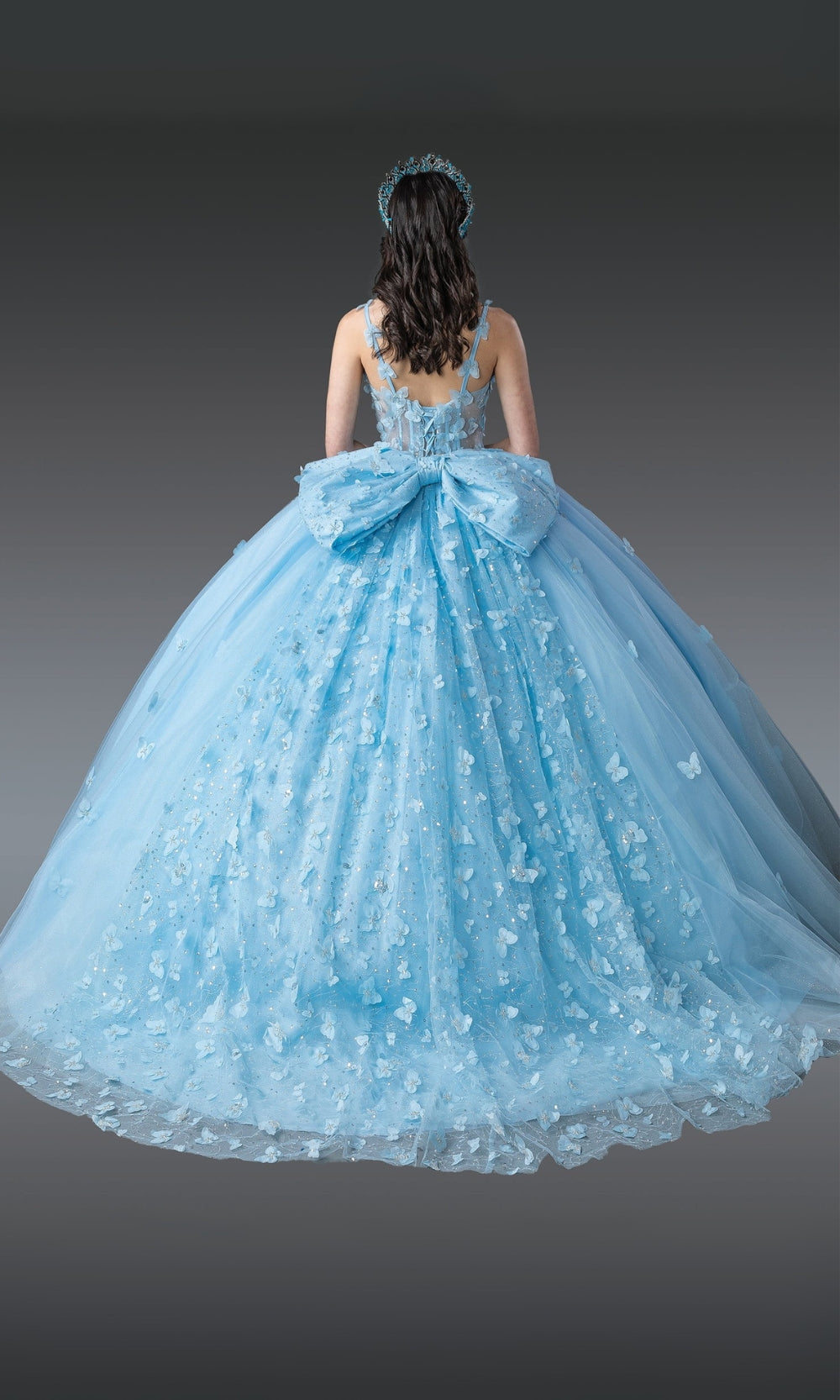 Light blue ball gown with a large bow on a gray background