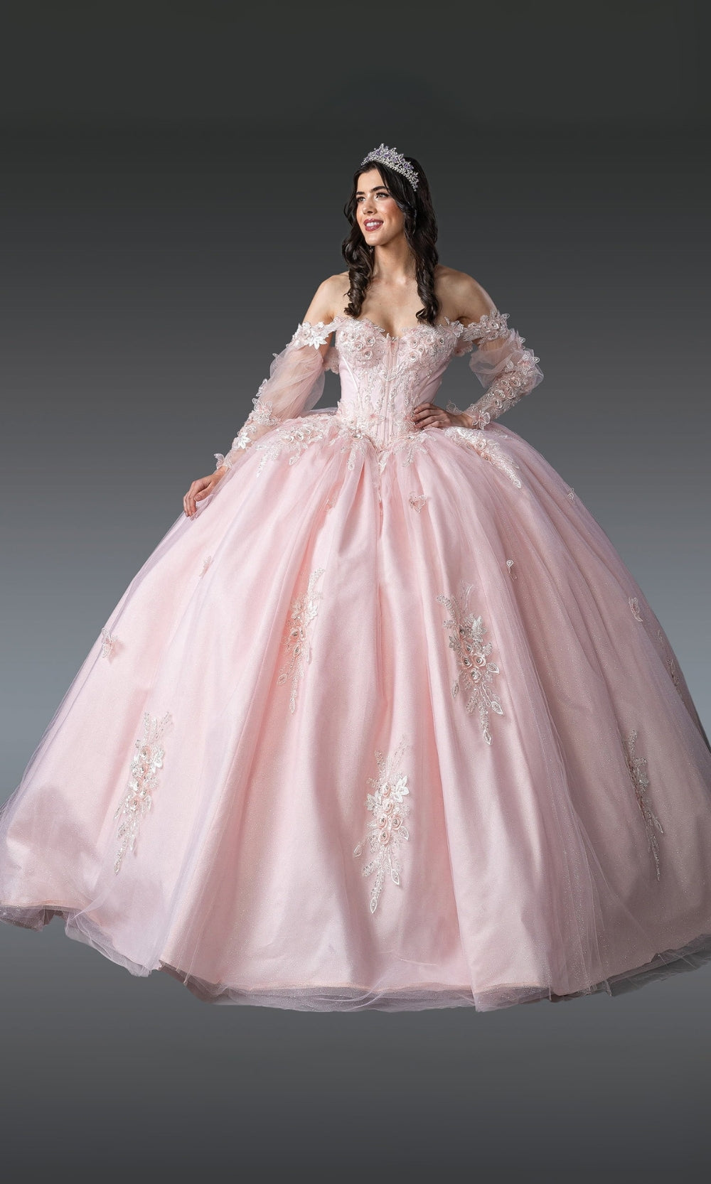 Pink ball gown with lace details on a dark background