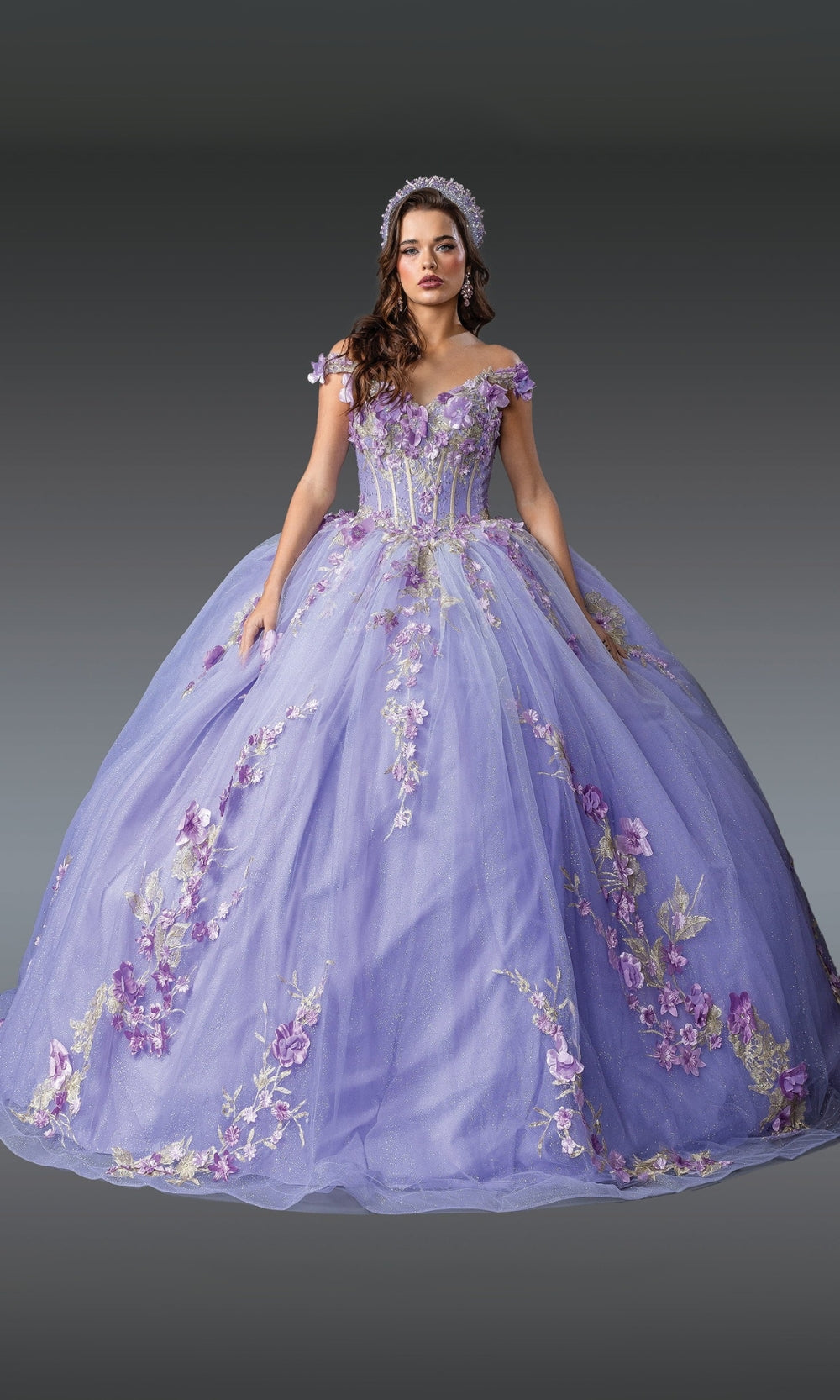 Woman wearing a lavishly decorated purple gown with floral embellishments on a gray background