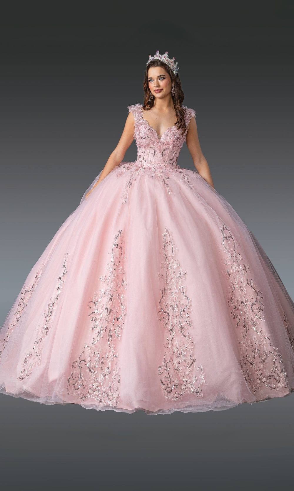 Pink ball gown with floral embroidery on a dark background