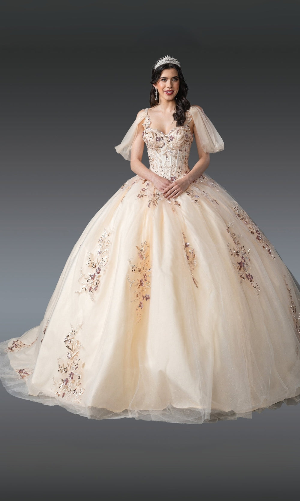 Beige wedding dress with floral embroidery on a plain background