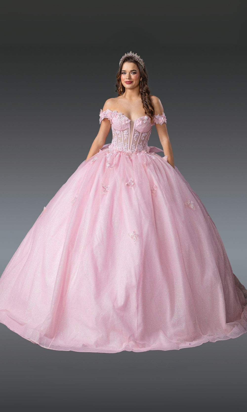 Pink ball gown with intricate details on a dark background