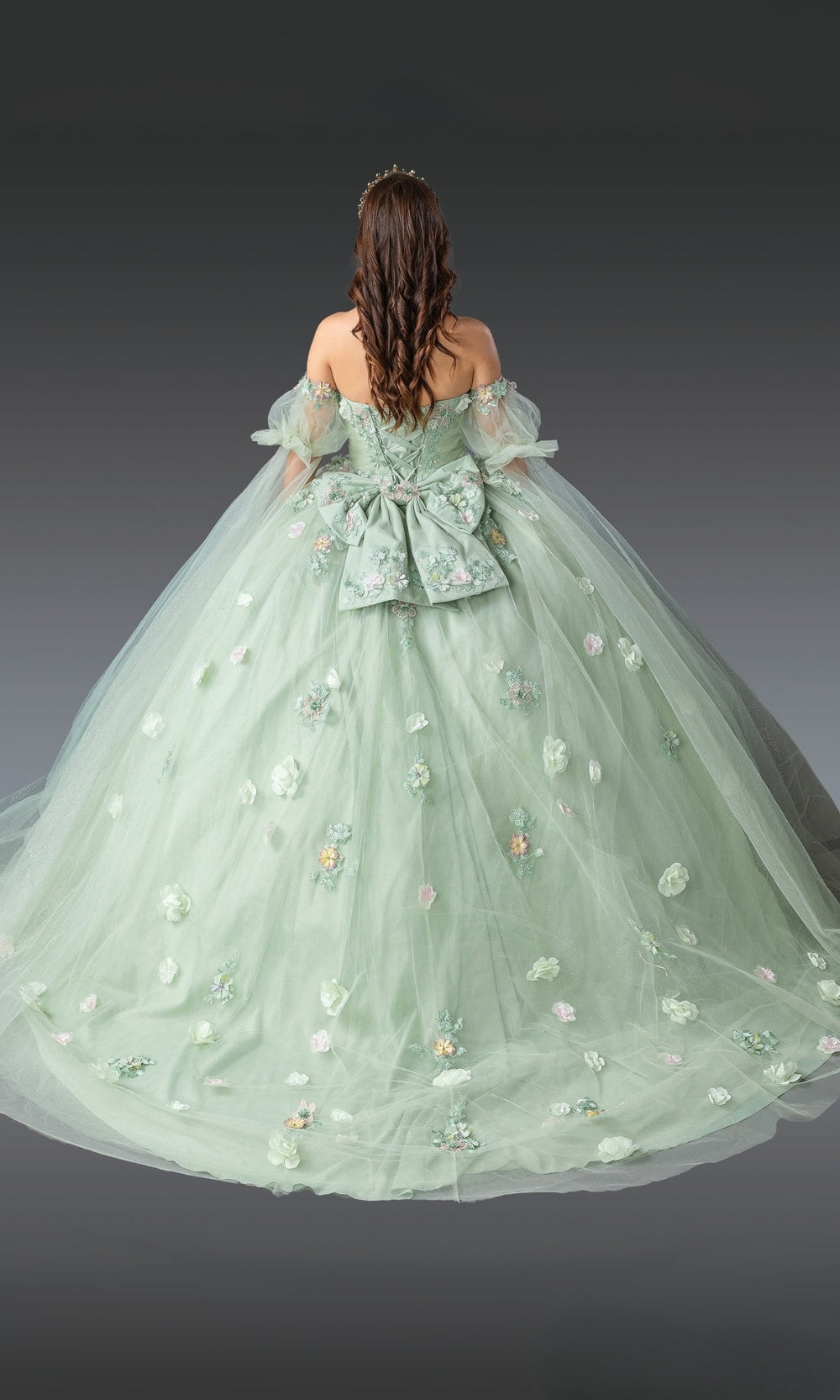 Green ball gown with floral details on a dark background