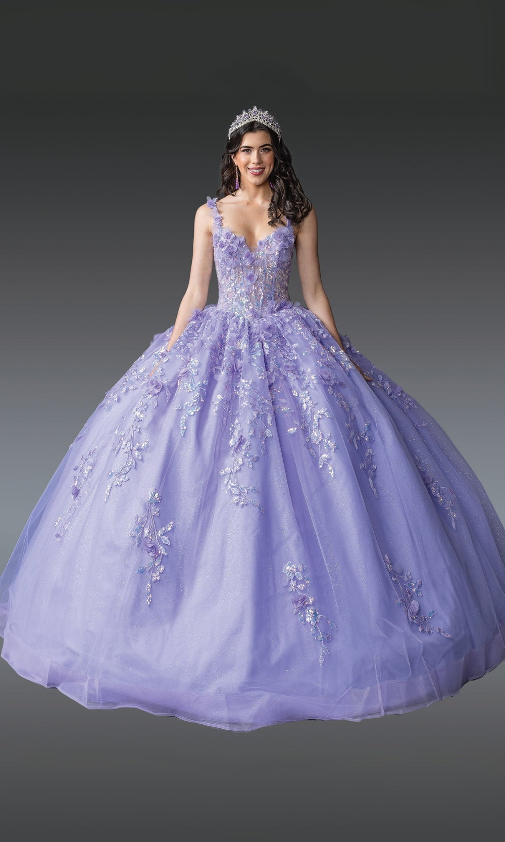 Woman wearing a purple ball gown with floral details on a gray background