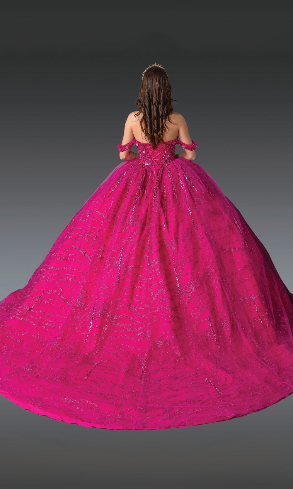 Pink ball gown with intricate details on a plain background