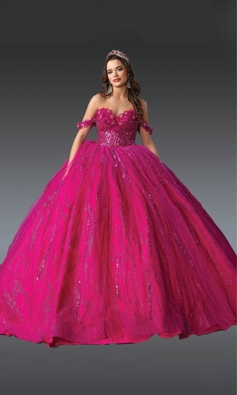 Pink quinceanera dress with floral details on a gray background